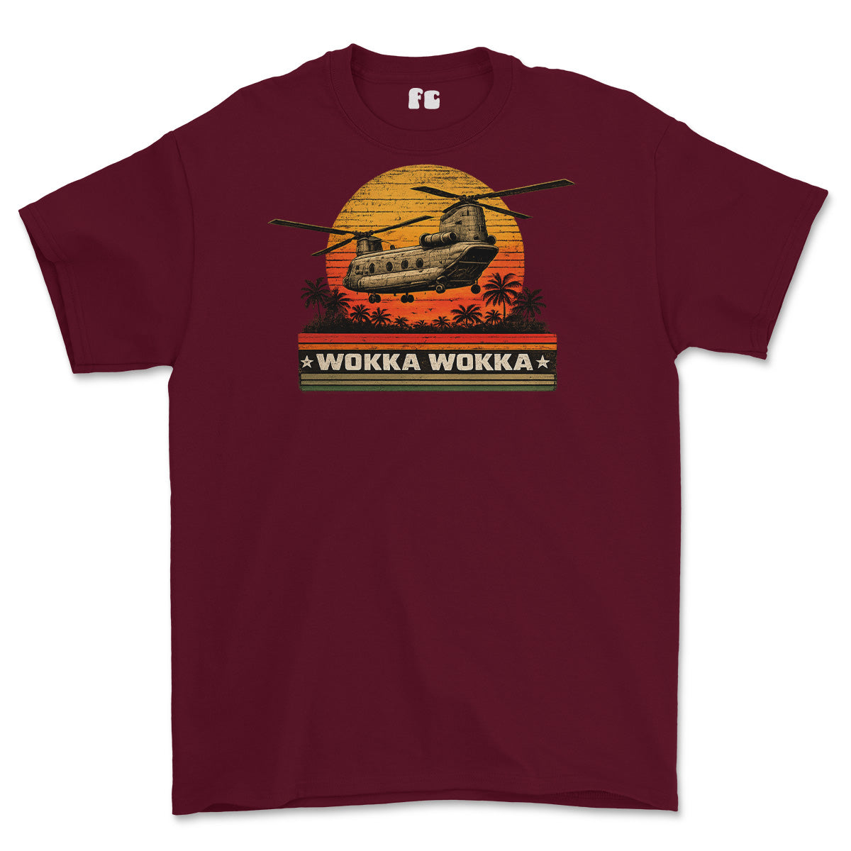 A maroon short-sleeve crewneck t-shirt featuring a retro graphic of a military CH-47 helicopter flying over a sunset with palm trees and the text 'WOKKA WOKKA'.
