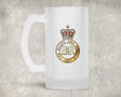 A frosted glass beer mug with a printed crest featuring a crown and the text 'BLUES AND ROYALS' with 'ER' in the center, set against a textured gray background.