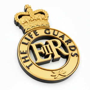 Gold and black emblem with 'The Life Guards' text and crown on a white background