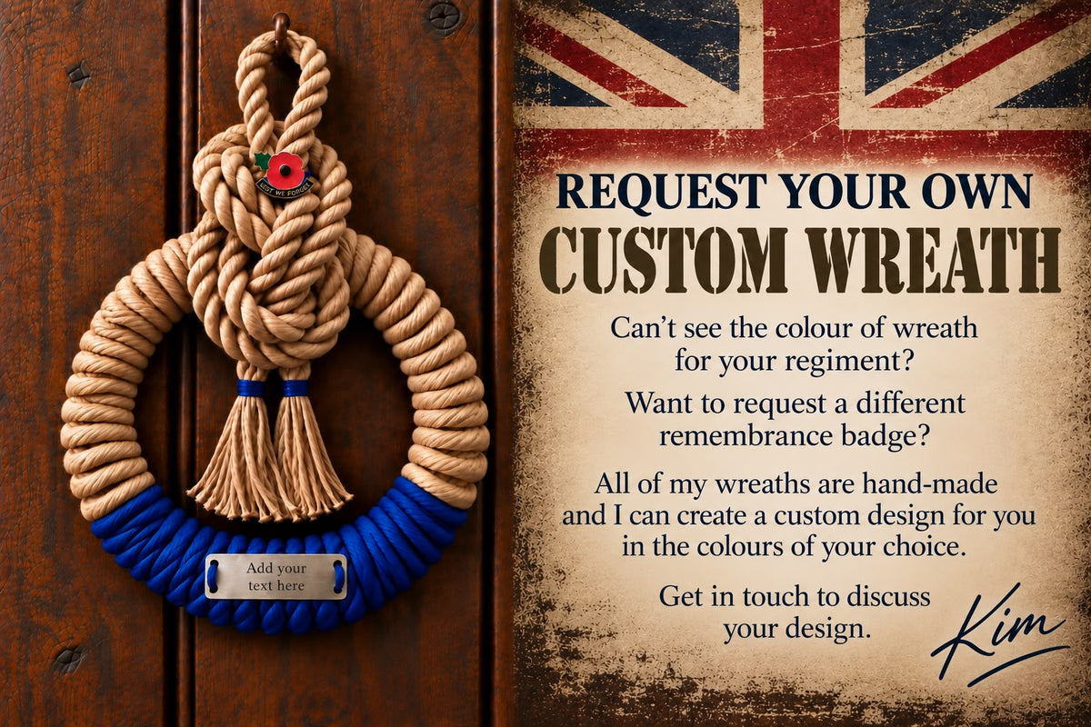 A rope memorial wreath with a blue braided base hangs on a dark wooden door next to a printed promotional card offering custom wreath designs. The wreath has a tan twisted rope top and a bright blue bottom with a small silver plaque reading 'Add your text here'.
