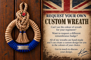 A rope memorial wreath with a blue braided base hangs on a dark wooden door next to a printed promotional card offering custom wreath designs. The wreath has a tan twisted rope top and a bright blue bottom with a small silver plaque reading 'Add your text here'.