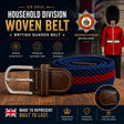 A woven British Household Division belt with brown leather trim and a silver buckle, shown in front of a dark promotional background featuring the words 'HOUSEHOLD DIVISION WOVEN BELT' and a soldier in a red uniform.