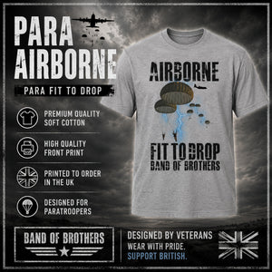 A light gray heathered t-shirt featuring a military 'Para Airborne' graphic with parachutists and lightning, displayed on a dark, dramatic background with promotional text overlays.