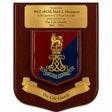 A wooden commemorative plaque with a polished gold-tone top inscription plate and a central shield featuring the Life Guards crest in red and blue with gold detailing, plus a gold scroll reading 'The Life Guards' at the bottom.